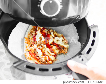Pizza in Fryer Air Basket New Cooker Hot Warm Food in Oven at Kitchen Italian Fastfood Piece in Utensil 111466685