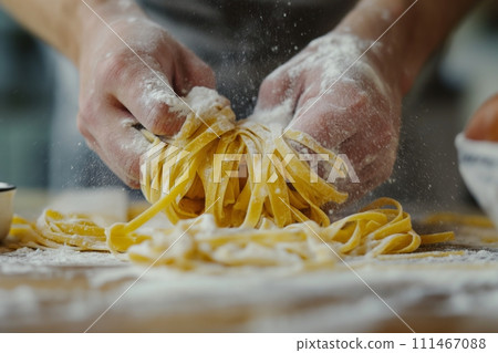 Close up view of hands making fresh italian pasta on wooden kitchen table Close up view of hands making fresh italian pasta on wooden kitchen table 111467088