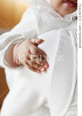 Close-up of baby's hand held by mother Close-up of baby's hand held by mother 111467451