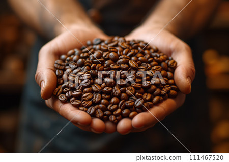 Men's palms full of golden roasted coffee beans 111467520