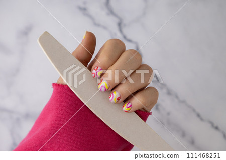 Pastel softness colorful manicured nails. Woman showing her new summer manicure in colors of pastel palette. Simplicity decor fresh spring vibes earth-colored neutral tones 111468251