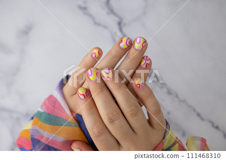 Woman manicured hands, stylish summer colorful nails. Closeup of manicured nails of female hand. Summer style of nail design concept. Beauty Woman manicured hands, stylish summer colorful nails. Closeup of manicured nails of female hand. Summer style of nail design concept. Beauty 111468310