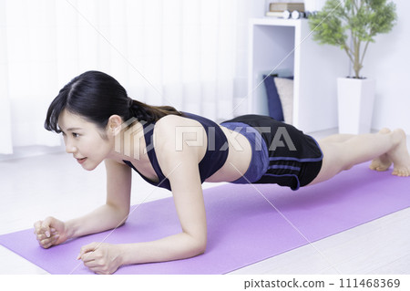 Middle-aged woman working out at home 111468369