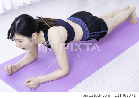Middle-aged woman working out at home Middle-aged woman working out at home 111468371