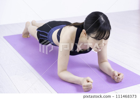 Middle-aged woman working out at home Middle-aged woman working out at home 111468373