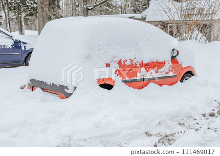 Parking of cars covered with snow. Heavy snowfall covered the road. Car in the snow.Consequences of a snowstorm.Abandoned car on the side of the road Parking of cars covered with snow. Heavy snowfall covered the road. Car in the snow.Consequences of a snowstorm.Abandoned car on the side of the road 111469017