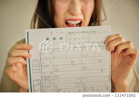 A woman in her 30s presents her husband with divorce papers A woman in her 30s presents her husband with divorce papers 111471092