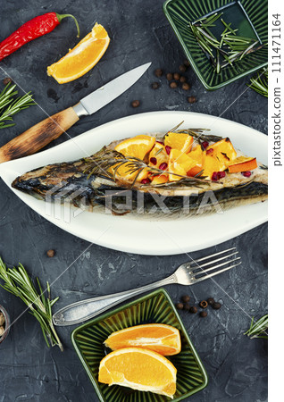Mackerel baked with oranges sauce. 111471164