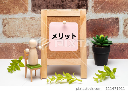 The word “merit” and a peg doll on a signboard The word “merit” and a peg doll on a signboard 111471911