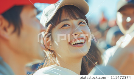 A young woman enthusiastically cheering for sports 111472574