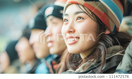 A young woman enthusiastically cheering for sports 111472576