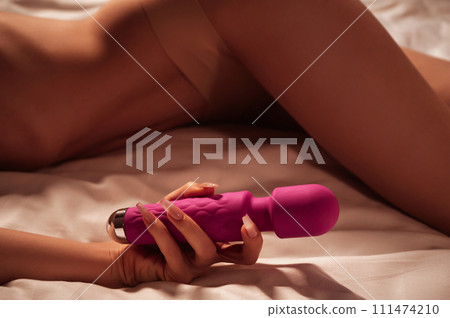 sex vibrator in hand of a woman girl with a... - Stock Photo [111474210] -  PIXTA
