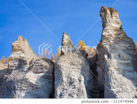 Stone pillars on the rocky shores of the Siberian taiga river in autumn. 111474946