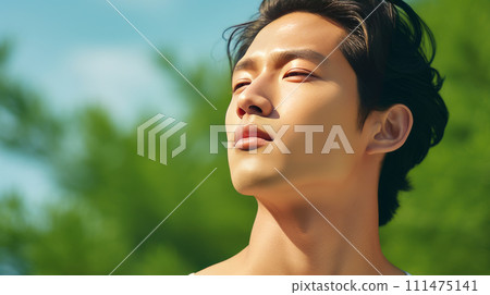 Elegant handsome young male Asian guy, on a light green background, banner, copy space, portrait. 111475141