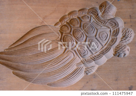 Wooden mold of an Edo rakugan carved from a 100-year-old tree. A wooden mold for sweets from a Japanese sweets shop in a townhouse that has been around since the Edo period in Morioka City, Iwate Prefecture. Wooden mold of an Edo rakugan carved from a 100-year-old tree. A wooden mold for sweets from a Japanese sweets shop in a townhouse that has been around since the Edo period in Morioka City, Iwate Prefecture. 111475947