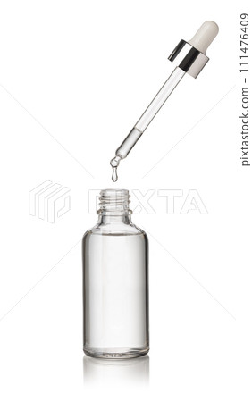 Drop falls from a pipette into a cosmetic bottle 111476409