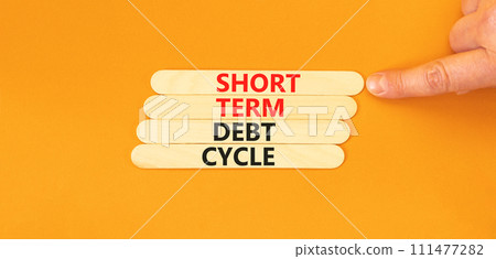 Short term debt cycle symbol. Concept words Short term debt cycle on wooden stick. Beautiful orange table orange background. Businessman hand. Business Short term debt cycle concept. Copy space. Short term debt cycle symbol. Concept words Short term debt cycle on wooden stick. Beautiful orange table orange background. Businessman hand. Business Short term debt cycle concept. Copy space. 111477282