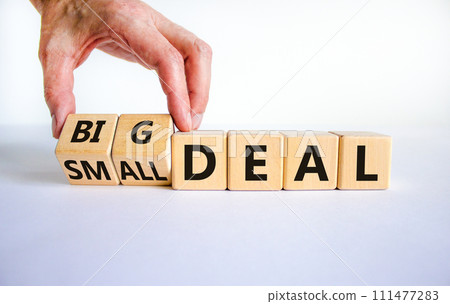 Big or small deal symbol. Businessman turns a wooden cube and changes words 'small deal' to 'big deal'. Beautiful white table, white background, copy space. Business and big or small deal concept. Big or small deal symbol. Businessman turns a wooden cube and changes words 'small deal' to 'big deal'. Beautiful white table, white background, copy space. Business and big or small deal concept. 111477283