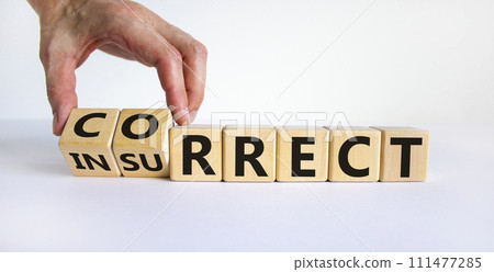Correct vs insurrect symbol. Businessman hand turns wooden cubes and changes the word 'insurrect' to 'correct'. Beautiful white background, copy space. Business, correct vs insurrect concept. 111477285
