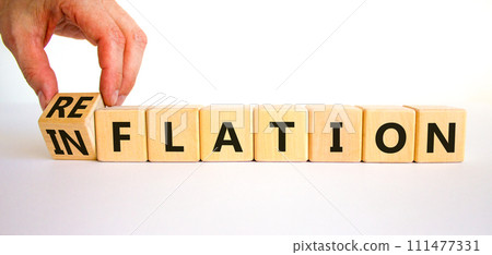 Reflation or inflation symbol. Concept word Reflation Inflation on beautiful wooden cubes. Beautiful white table white background. Businessman hand. Business reflation or inflation concept. Copy space Reflation or inflation symbol. Concept word Reflation Inflation on beautiful wooden cubes. Beautiful white table white background. Businessman hand. Business reflation or inflation concept. Copy space 111477331