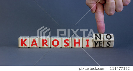 Karoshi yes or no symbol. Concept words Karoshi Yes or No on beautiful wooden blocks. Beautiful grey table grey background. Businessman hand. Business and stop karoshi concept. Copy space. Karoshi yes or no symbol. Concept words Karoshi Yes or No on beautiful wooden blocks. Beautiful grey table grey background. Businessman hand. Business and stop karoshi concept. Copy space. 111477352