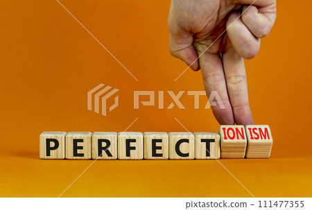 Perfectionism symbol. Concept words Perfect or Perfectionism beautiful wooden blocks. Beautiful orange background. Businessman hand. Business and perfectionism or perfect concept. Copy space. Perfectionism symbol. Concept words Perfect or Perfectionism beautiful wooden blocks. Beautiful orange background. Businessman hand. Business and perfectionism or perfect concept. Copy space. 111477355