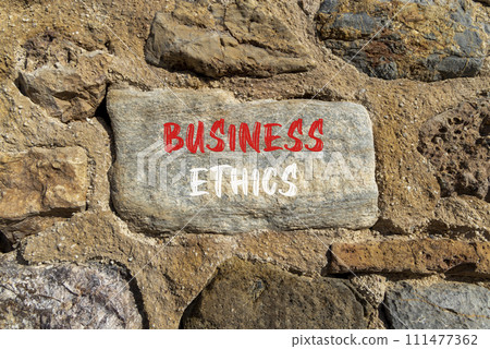 Business ethics symbol. Concept words Business ethics on beautiful grey stone. Beautiful brown stone wall background. Business ethics concept. Copy space. Business ethics symbol. Concept words Business ethics on beautiful grey stone. Beautiful brown stone wall background. Business ethics concept. Copy space. 111477362
