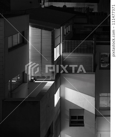 Abstract urban night scene with architectural elements and light contrasts Abstract urban night scene with architectural elements and light contrasts 111477371
