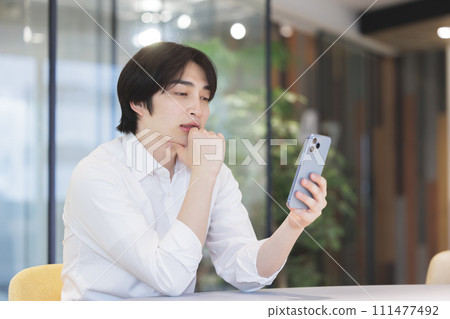 A man operating a smartphone 111477492
