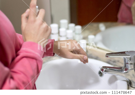 Cropped image of woman applying cream to her hand 111478647