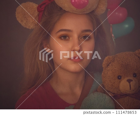 Child with a plush toy. 111478653