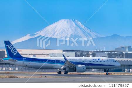 Japanese passenger plane and snow-covered Mt. Fuji 111479867
