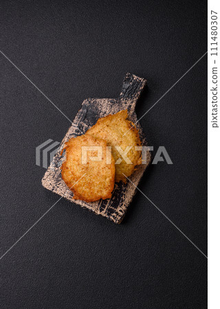 Delicious crispy pancakes made from potatoes, meat, carrots, onions 111480307