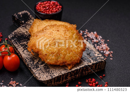 Delicious crispy pancakes made from potatoes, meat, carrots, onions 111480323