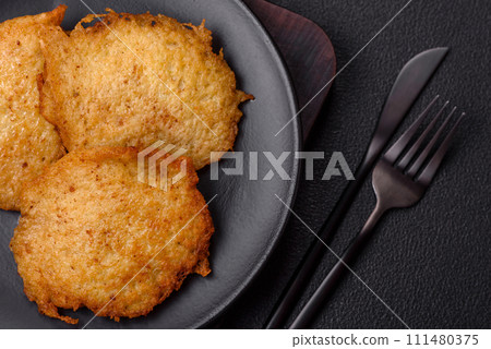 Delicious crispy pancakes made from potatoes, meat, carrots, onions 111480375