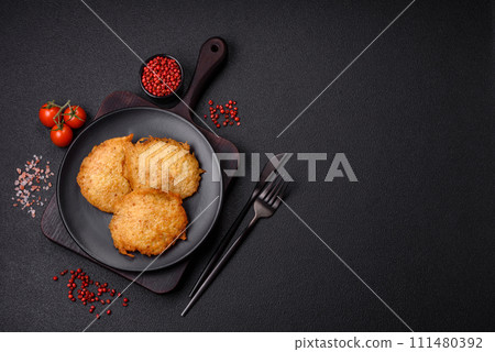 Delicious crispy pancakes made from potatoes, meat, carrots, onions 111480392