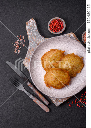 Delicious crispy pancakes made from potatoes, meat, carrots, onions 111480415