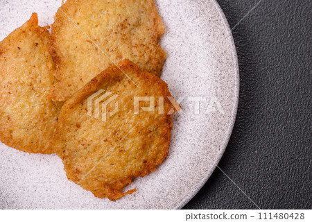 Delicious crispy pancakes made from potatoes, meat, carrots, onions 111480428