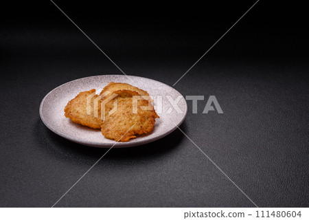 Delicious crispy pancakes made from potatoes, meat, carrots, onions 111480604