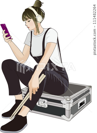 Drummer woman listening to music with headphones 111482264