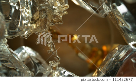 Pouring Whiskey into Glass, Macro Shot. 111482677