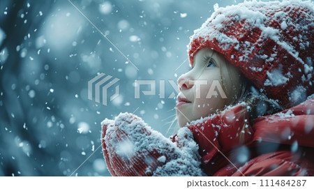 A child's first encounter with snow, touching the cold with wonder and amazement 111484287