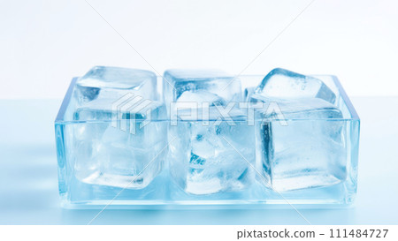 Transparent ice cubes neatly stacked in a glass container, symbolizing coolness and freshness 111484727