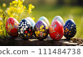Colorful painted Easter eggs bask in sunlight amidst a bright yellow flower field. Banner with copy space 111484738
