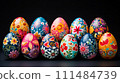 Collection of vibrant intricately hand-painted Easter eggs against a dark background 111484739