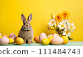 Bunny with Easter Eggs and Daffodils on Yellow background. Cute rabbit surrounded by Easter eggs and flowers against a vibrant yellow backdrop 111484743