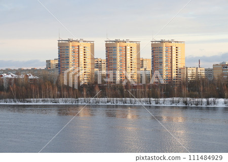 river on a sunny evening. Trees and shrubs. Landscape of winter nature, river banks with bushes. 111484929