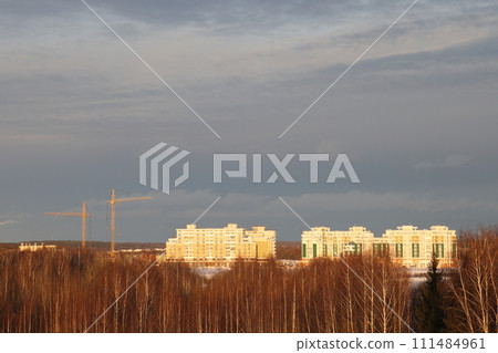 New snow covered high rise residential buildings in a Russian city. Moscow region, January 2022. 111484961