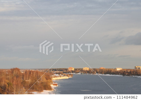river on a sunny evening. Trees and shrubs. Landscape of winter nature, river banks with bushes. 111484962