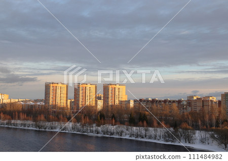 river on a sunny evening. Trees and shrubs. Landscape of winter nature, river banks with bushes. 111484982